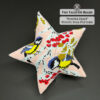 Winter Feast beaded star ornament on black background