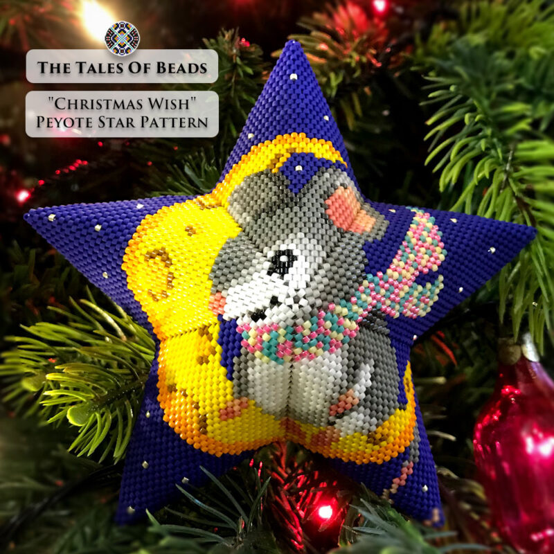 beaded star ornament with mouse happily sitting on a crescent moon made of cheese hanging on a Christmas tree