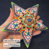 The Carnival beaded star ornament held in hand
