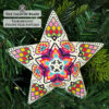 A 3D beaded star with a vibrant motif used as a Christmas tree decoration