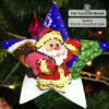 beaded star ornament with Santa leaving a cabin decorated with festive lights hanging on a Christmas tree