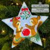 beaded star ornament with a couple of squirrels under a mistletoe hanging on a Christmas tree