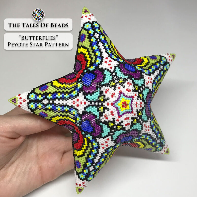 The Butterflies beaded star ornament held in hand