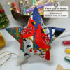 Flat lay of the finished Cardinals Peyote Star with bead tubes and Christmas decor
