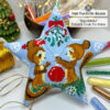 Flat lay of the finished Squirrels Peyote Star surrounded by craft supplies and Christmas decor