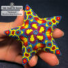 The Pharaoh beaded star ornament held in hand