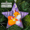 beaded star ornament with mother fox and her cub sleeping snuggly in the forest hanging on a Christmas tree