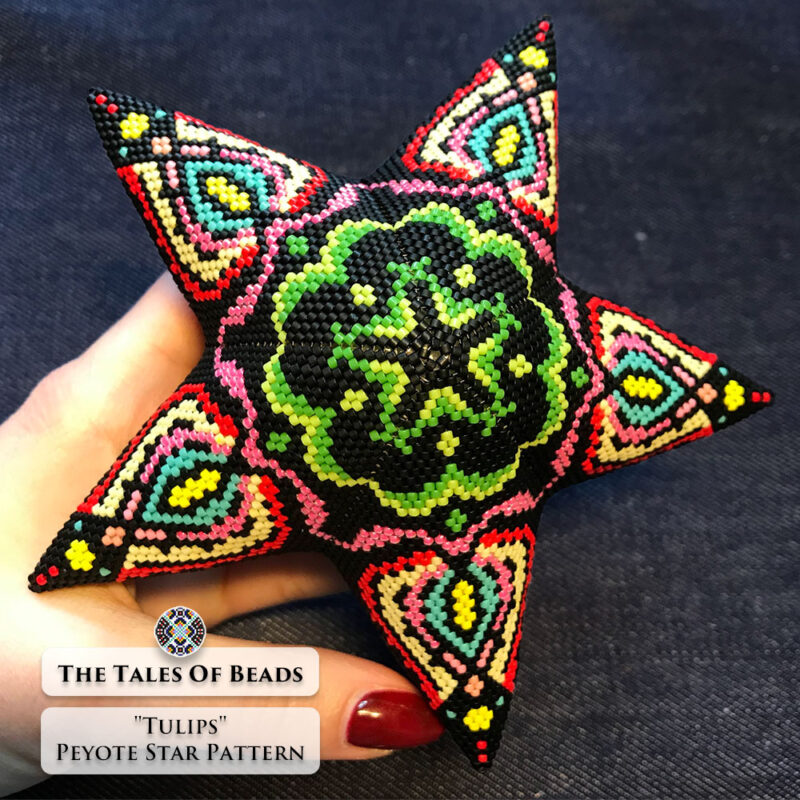 The Tulips beaded star ornament held in hand