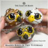A picture of three Beaded Birds of Prey held in hand to show size scale