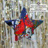 Close-up of cardinals on peyote star ornament with gold tinsel in the background