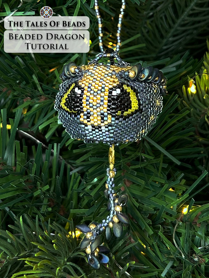 Vertical image of a seed bead dragon ornament used as Christmas tree decoration