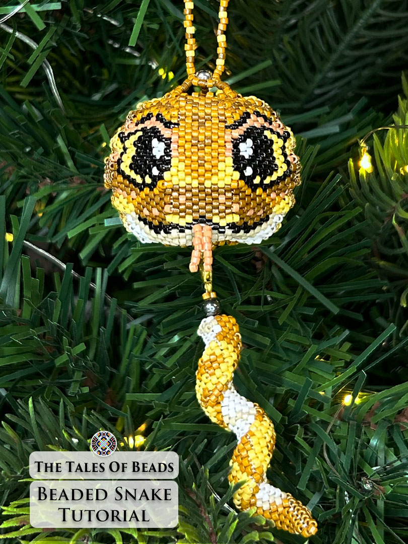 Vertical image of a seed bead python used as year of the snake ornament