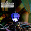 A seed bead lantern ornament accommodating a mini LED light used as plant decoration
