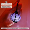 A glowing round seed bead lantern with a mini LED light held in hand