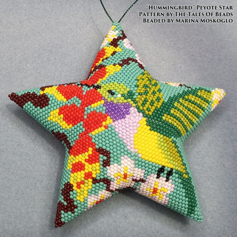 A peyote star featuring a hummingbird and tropical flowers