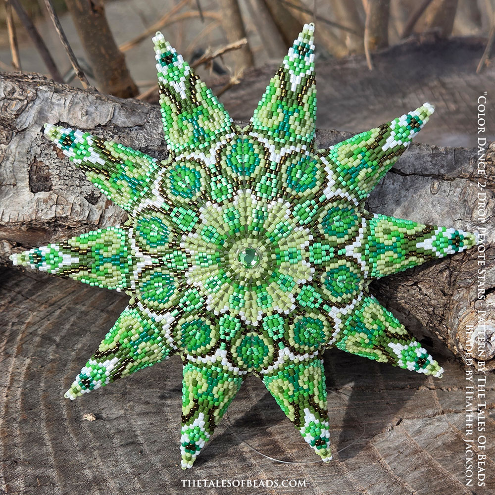 Ten point peyote star in shades of green displayed on rustic wooden stump