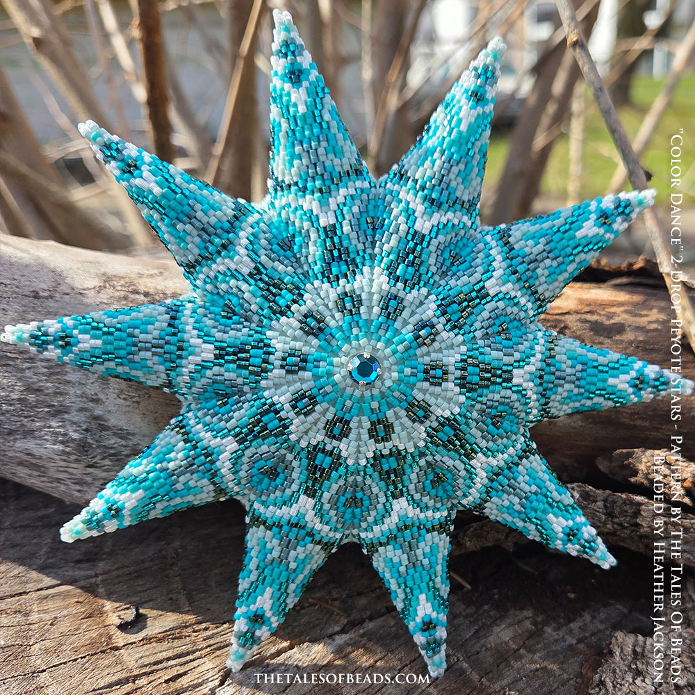 Peyote star with a geometric design in shades of turquoise displayed on rustic wooden stump, Christmas craft idea