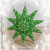St Patrick's Day Beaded Ornament - Ten point peyote star in shades of green showcased on a gold display stand