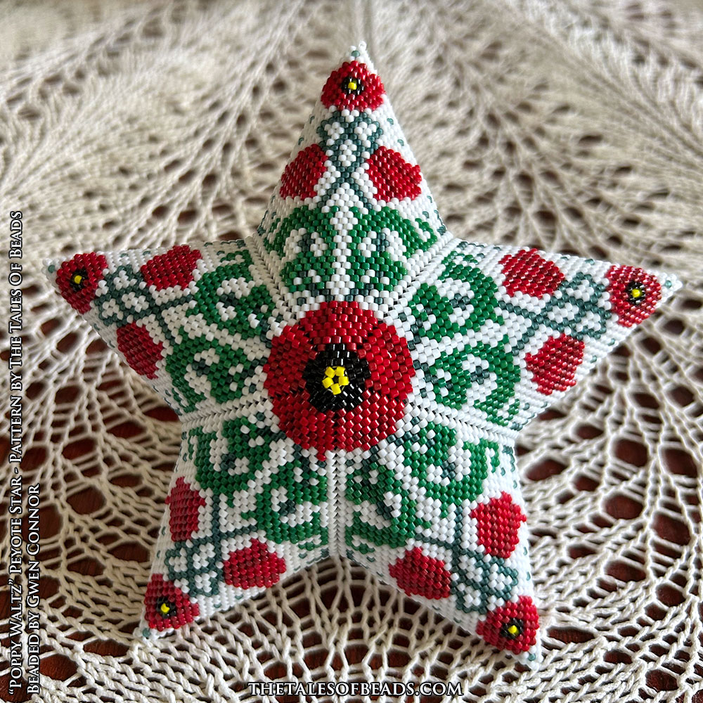 Peyote star with entwined poppies design showcased on a lace tablecloth